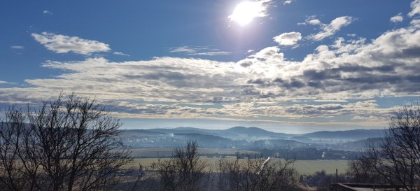 Sunny summer day with clouds over the valley