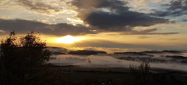 Sunset with clouds and fog in the valley