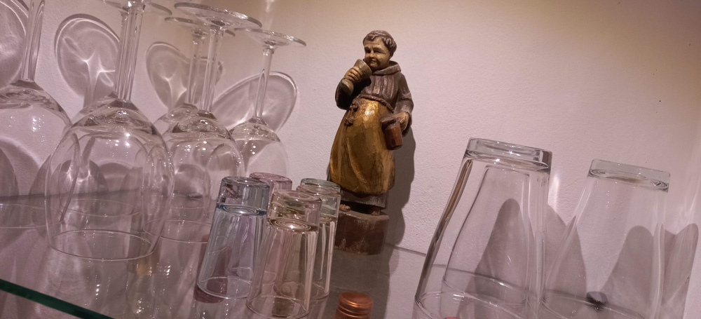 Wine glasses and a statue of a monk